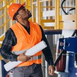 african-american-worker-standing-uniform-wearing-safety-hat-factory_1303-30606